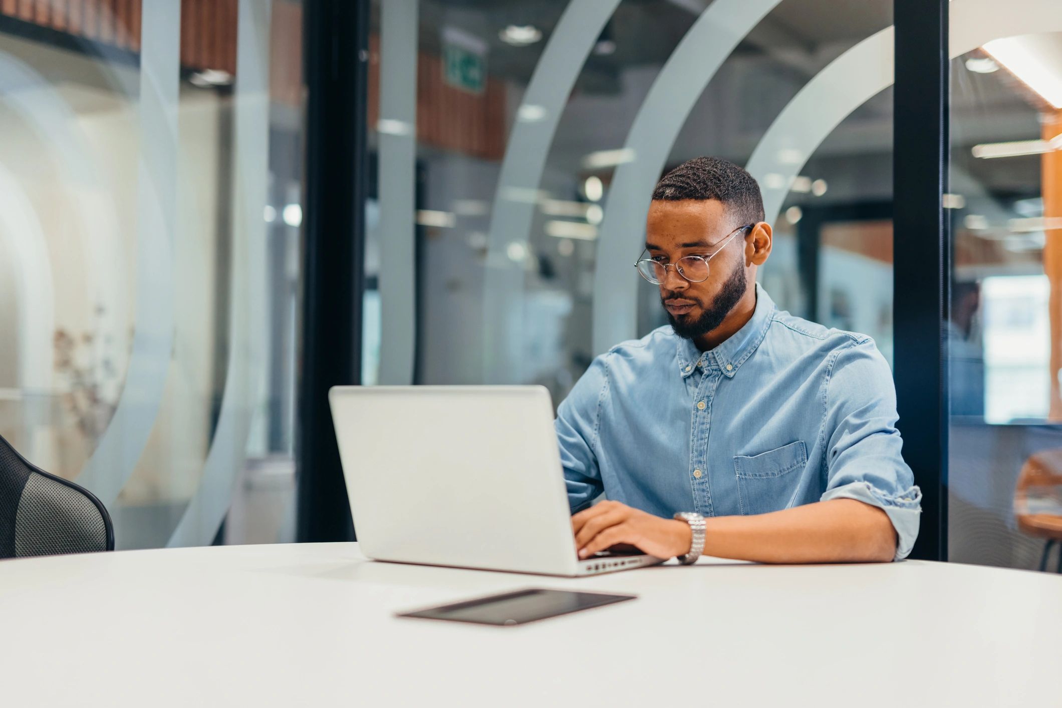 App developer working on a laptop in a modern workspace