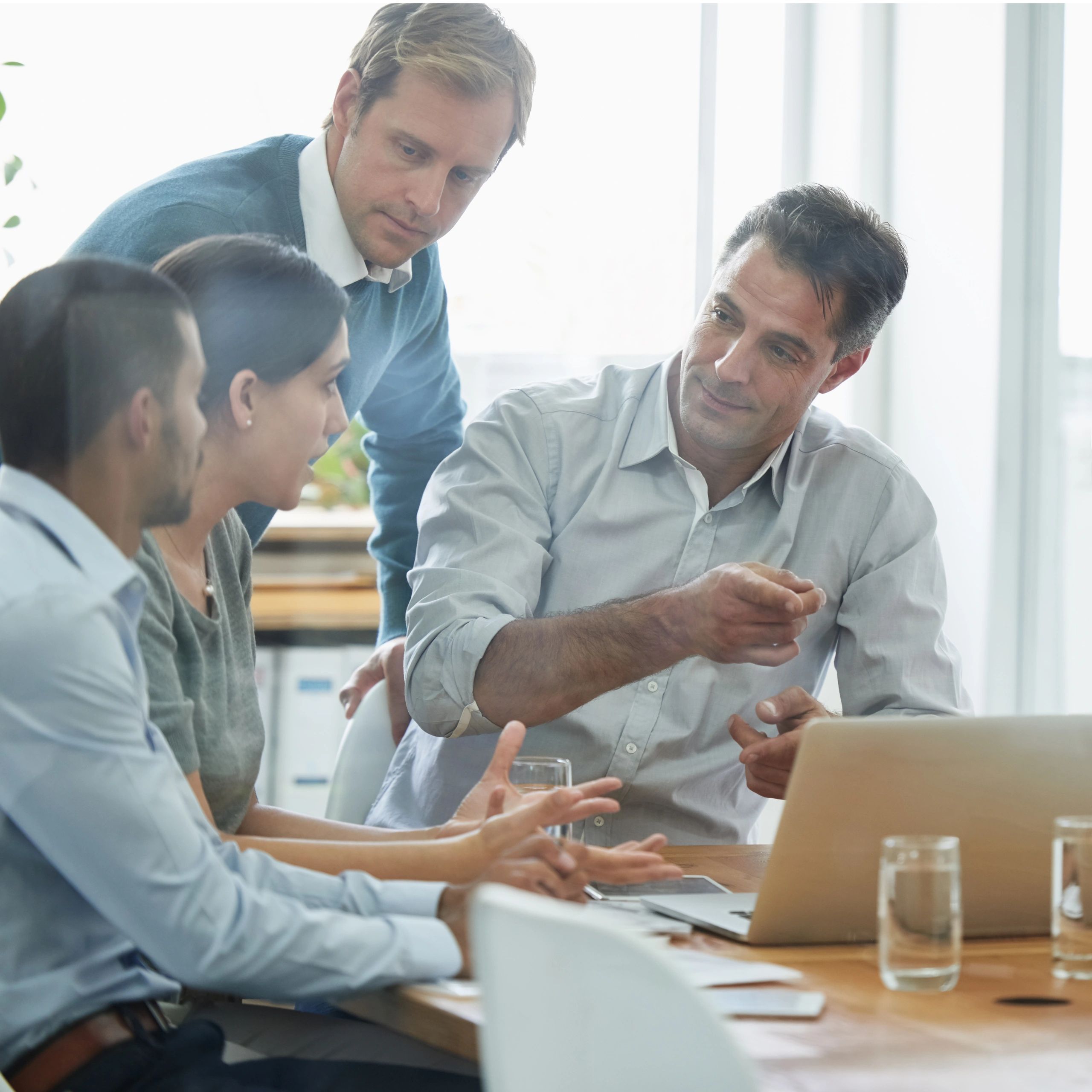 Professionals collaborating in a meeting with devices